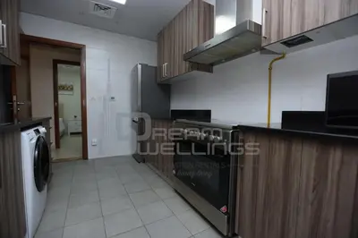 a kitchen with a counter and a washer and dryer at Downtown Dunya Tower in Dubai