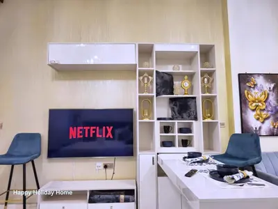 a living room with a tv on a wall at Burj Khalifa view studio apartment in Business bay, Downtown in Dubai