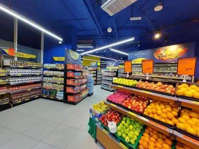 a grocery store aisle with fruits and vegetables on display at Burj Khalifa view studio apartment in Business bay, Downtown in Dubai