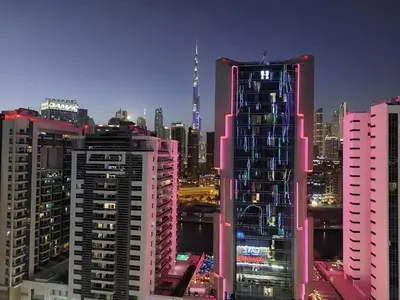 a group of tall buildings in a city at night at Burj Khalifa view studio apartment in Business bay, Downtown in Dubai