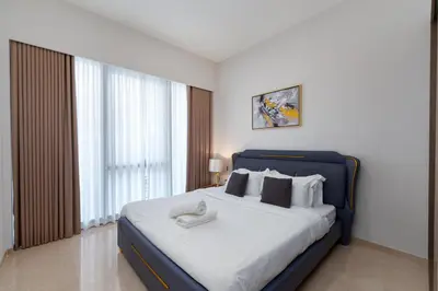 a bedroom with a large bed with a blue frame at Elegant Downtown Retreat in Dubai