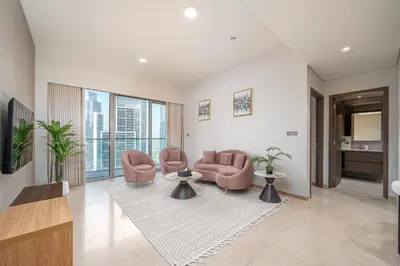 a living room with two chairs and a table at Elegant Downtown Retreat in Dubai