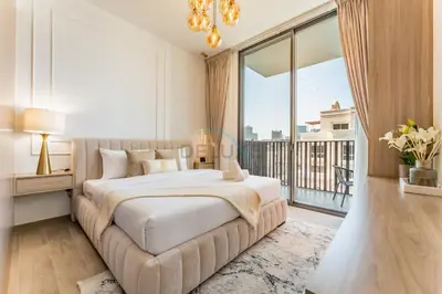 a bedroom with a large bed and a large window at Brand New Building with Resort-style Amenities, Hamilton House, JVC By Deluxe Holiday Homes in Dubai