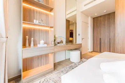 a bedroom with a white bed and a mirror at Brand New Building with Resort-style Amenities, Hamilton House, JVC By Deluxe Holiday Homes in Dubai