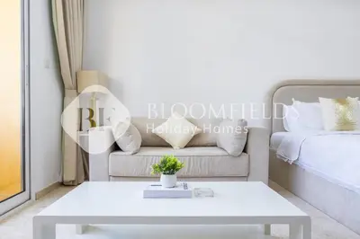 a living room with a couch and a table at Bloomfields Luxurious Stu in Mulberry 1 Emirates in Dubai