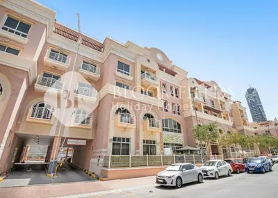 a large building with cars parked in front of it at Bloomfields Luxurious Stu in Mulberry 1 Emirates in Dubai