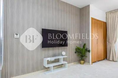 a room with a wall with a sign on it at Bloomfields Luxurious Stu in Mulberry 1 Emirates in Dubai