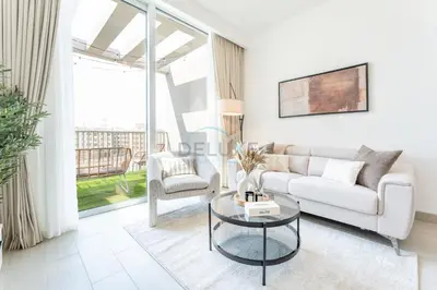 a living room with a white couch and a glass table at New 1 BR with 2 Balconies Near Circle Mall, Luma22 West Tower, JVC By Deluxe Holiday Homes in Dubai