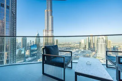 a balcony with a table and a chair on a building at Grande Signature Residences Luxury 3BR - Burj View in Dubai Downtown in Dubai