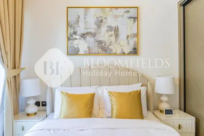 a bedroom with a bed with yellow pillows at Bloomfields Cozy 1Br In Binghatti Creek in Dubai