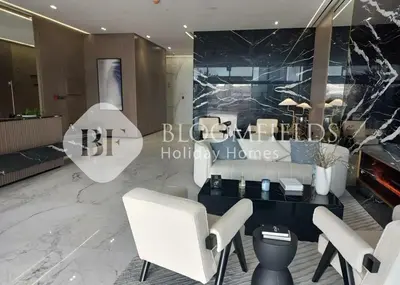 a lobby of a hotel with white chairs and a table at Bloomfields Cozy 1Br In Binghatti Creek in Dubai