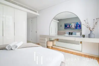 a bedroom with a white bed and a mirror at LUX The Bluewaters Island Suite 2 in Dubai