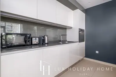 a kitchen with a counter with a toaster oven and a microwave at LUX The Bluewaters Island Suite 2 in Dubai