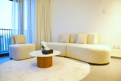 a living room with a white couch and a table at Comfortable 2BR Stay with Sea View in Dubai