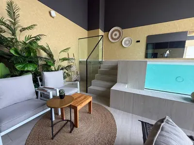 a living room with a couch and a table at BLVD - Luxe Retreat - Stylish Stay with Full Privacy in Dubai