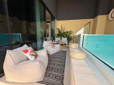 a living room with a couch and a large tv at BLVD - Luxe Retreat - Stylish Stay with Full Privacy in Dubai