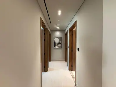 a hallway with doors and a mirror in a room at BLVD - Luxe Retreat - Stylish Stay with Full Privacy in Dubai