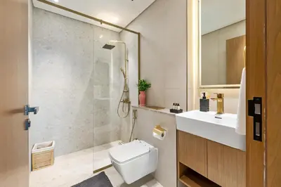 a bathroom with a shower and a toilet and a sink at BLVD - Luxe Retreat - Stylish Stay with Full Privacy in Dubai