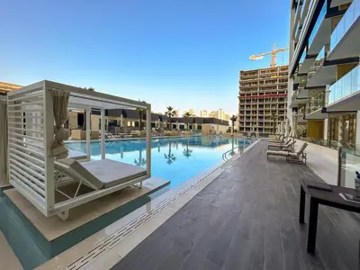 a building with a swimming pool with avisorvisorvisorvisor at BLVD - Luxe Retreat - Stylish Stay with Full Privacy in Dubai