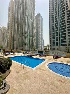 a swimming pool in a city with tall buildings at Prime Marina Location Stylish Apartment in Princess Tower in Dubai