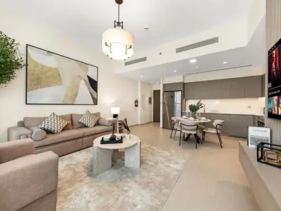 a living room with a couch and a table at Grande Signature Burj Khalifa and Fountain View 2BD Apartment 35th Floor in Dubai