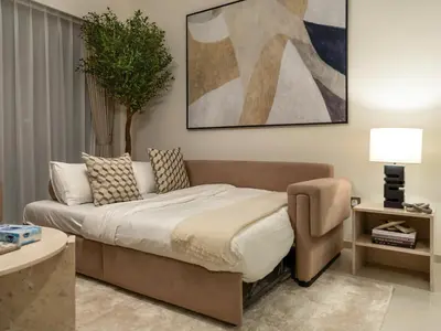 a bedroom with a bed and a chair in it at Grande Signature Burj Khalifa and Fountain View 2BD Apartment 35th Floor in Dubai