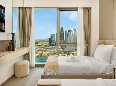 a hotel room with a bed and a large window at Grande Signature Burj Khalifa and Fountain View 2BD Apartment 35th Floor in Dubai