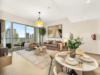 a living room with a table and chairs at Grande Signature Burj Khalifa and Fountain View 2BD Apartment 35th Floor in Dubai
