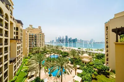an aerial view of a resort with palm trees and the ocean at Luxury Fairmont Palm - Beach Access & Sea View in Dubai
