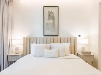 a bedroom with a large bed with white pillows at TRPS - Ahad Residences, Business Bay - 1BR Luxurious Apartment - Massive Balcony with Pool View in Dubai
