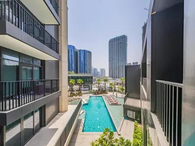 an overhead view of a swimming pool between two buildings at TRPS - Ahad Residences, Business Bay - 1BR Luxurious Apartment - Massive Balcony with Pool View in Dubai