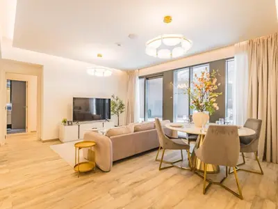 a living room with a couch and a table at TRPS - Ahad Residences, Business Bay - 1BR Luxurious Apartment - Massive Balcony with Pool View in Dubai