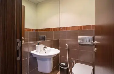 a bathroom with a sink and a toilet at Granduer 1 BR in Windsor Manor Canal Front Living With Burj Views in Dubai