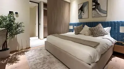 a bedroom with a large bed in a room at Bespoke Holiday Homes - Stylish 1BR Penthouse in The Autograph in Dubai
