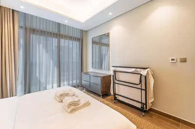 a bedroom with a bed and a tv in it at Contemporary 1BR Prime Location with Parking in Dubai