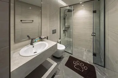 a bathroom with a sink and a shower and a toilet at Contemporary 1BR Prime Location with Parking in Dubai