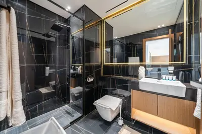 a bathroom with a toilet and a sink and a shower at Modern JVC Apartment Views of Marina Skylines in Dubai