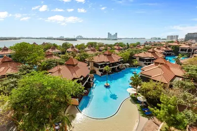 an aerial view of a resort with a swimming pool at Homely 1 Bedroom on Palm Jumeirah with private beach in Dubai