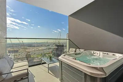 a bathroom with a hot tub on a balcony at Stylish Studio with Jacuzzi in Business Bay in Dubai