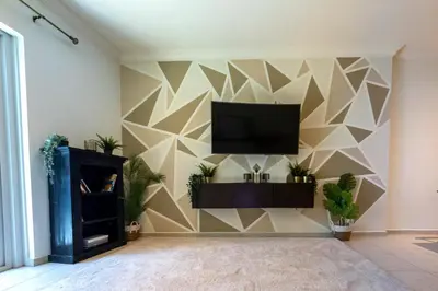 a living room with a tv on a wall at Marina Mirage in Dubai
