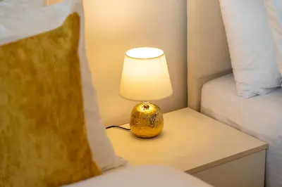 a lamp sitting on a table next to a bed at LUX New Studio With 2 Double Beds in Downtown Dubai, Pool View, Free Parking in Dubai