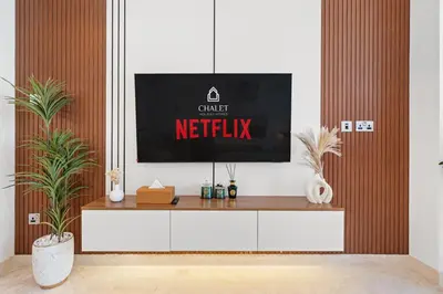 a tv sitting on top of a tv stand in a living room at LUX New Studio With 2 Double Beds in Downtown Dubai, Pool View, Free Parking in Dubai