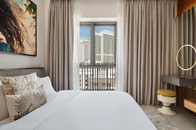 a bedroom with a large bed and a large window at qua Serenity Poolside with Community Views in Dubai