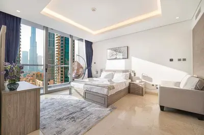 a bedroom with a bed and a large window at Luxe 1BR Burj View 10 min Walk to Dubai Mall in Dubai