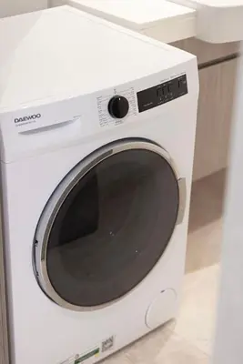 a white washing machine sitting in a kitchen at Luxe 1BR Burj View 10 min Walk to Dubai Mall in Dubai