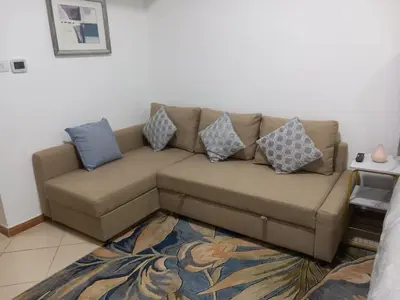 a brown couch with pillows on it in a living room at Diamond Studio Marina in Dubai