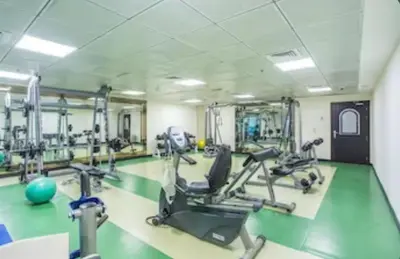 a gym with treadmills and ellipticals in a room at Diamond Studio Marina in Dubai