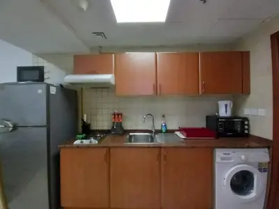 a small kitchen with a sink and a refrigerator at Diamond Studio Marina in Dubai
