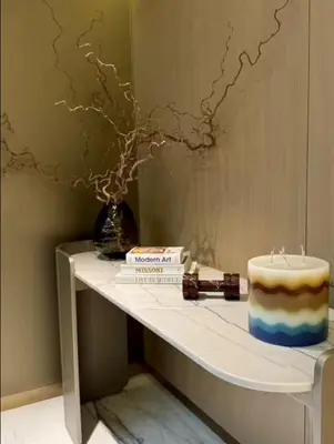 a table with a cake sitting on a shelf at Mahogany 10 - 2BR 8 PAX - Infinity Pool & Modern in Dubai