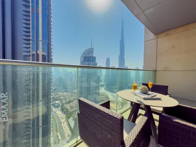 a balcony with a table and chairs on a building at The Address Fountain Views Residence High Floor with Burj Khalifa view and access to Dubai mall in Dubai